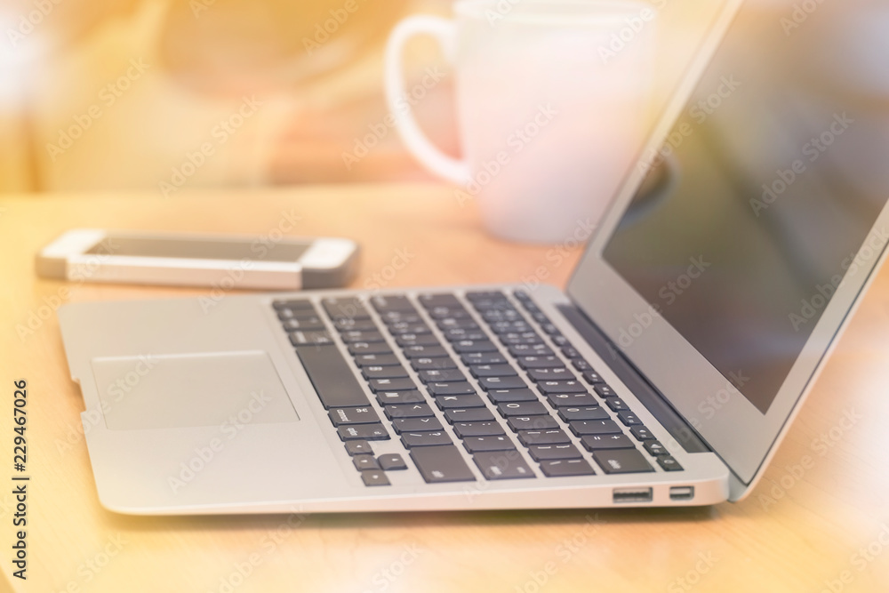 LAPTOP, SMART PHONE, AND A CUP OF COFFEE ON TABLE AT WORKPLACE LAPTOP, SMART PHONE, AND A CUP OF COFFEE ON TABLE AT WORKPLACE