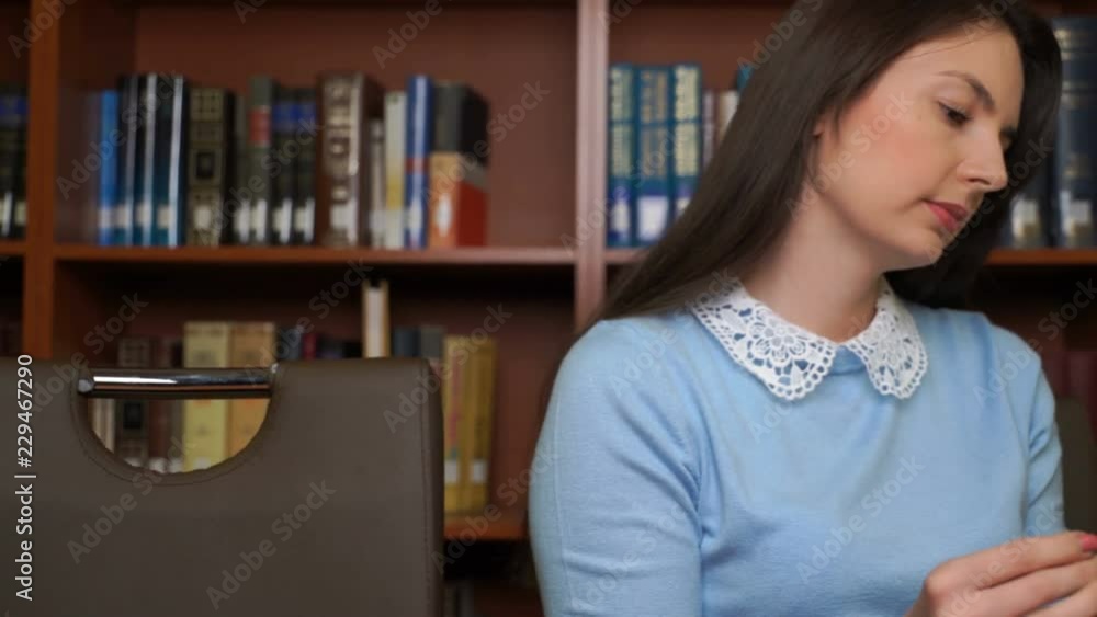pretty woman read book in library office. pretty woman read book in library office.