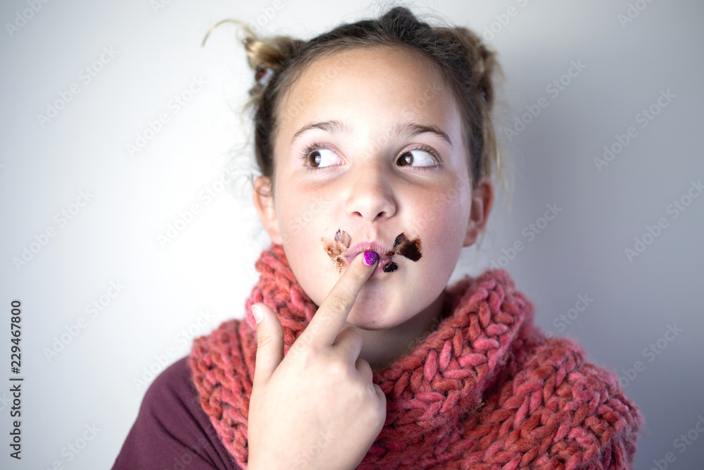 Young girl with messy chocolate face. Young girl with messy chocolate face.