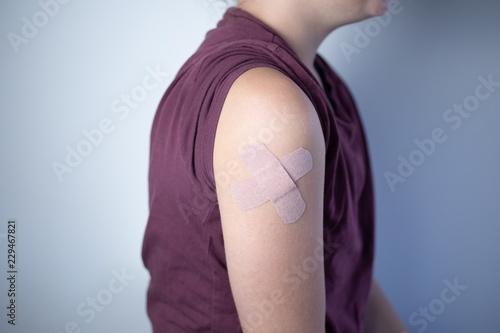 Fotografie, Obraz Criss crossed bandages on shoulder of child.