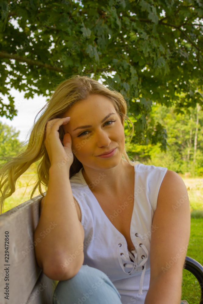 Summer woman in a park with Jean pants Summer woman in a park with Jean pants