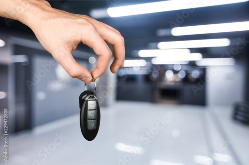 Hand with a car key. Isolated on