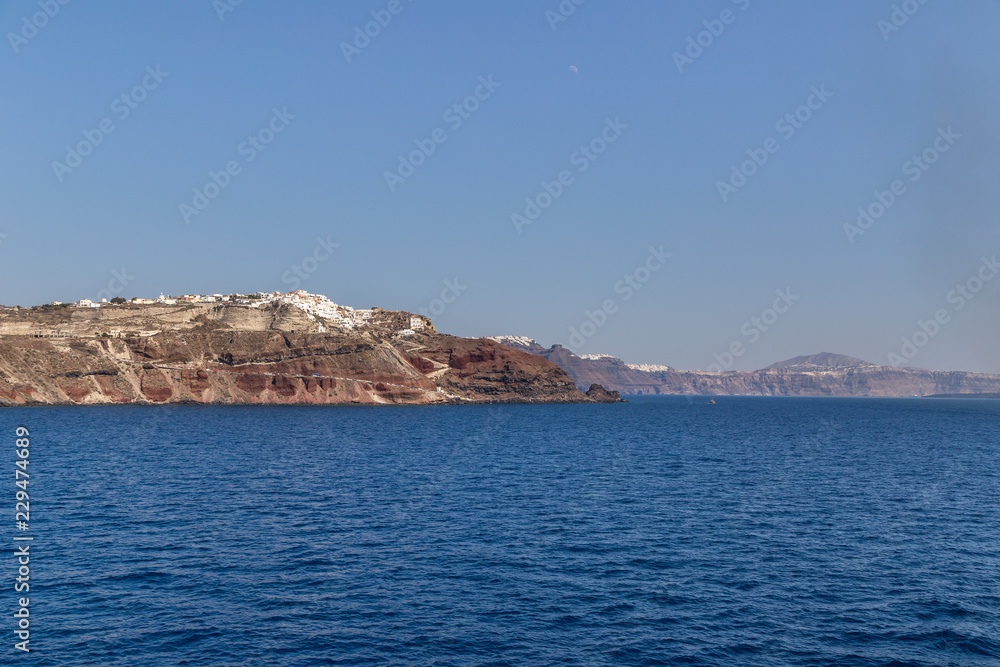 Landscape of famous Santorini with white houses on hill