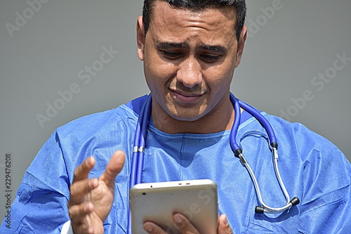Confused Male Surgeon Wearing Scrubs