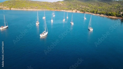 Flying over yachts or sailing boats at the marina of Spetses island, one of the Saronic Islands in the Aegean sea, Greece.