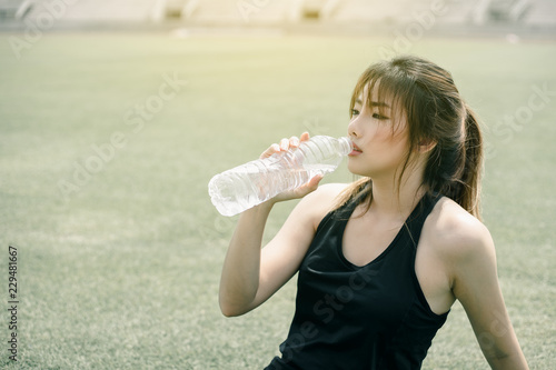 Asian woman with sport clothing exercise outdoor.  Modern women healthy lifestyle. 
