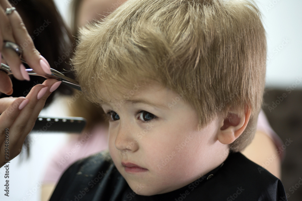Making haircut fun. Little child given haircut. Small child in hairdressing  salon. Little boy with blond hair at hairdresser. Cute boys hairstyle. Hair  salon for kids. Having short haircut Stock Photo |