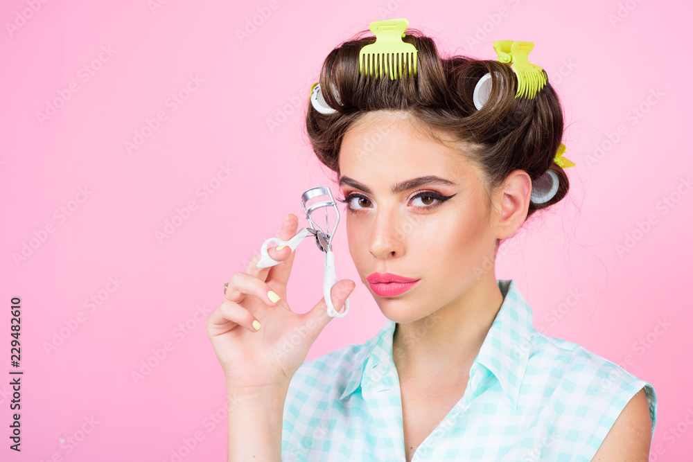 vintage housewife woman curl eyelashes with tool. Pinup girl. beauty salon and hairdresser. retro woman with fashion makeup and hair. happy girl grooming in morning, copy space. Stylish and confident