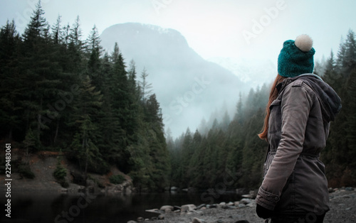 woman looking at misty mountains