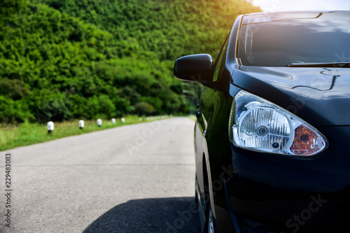 Car parked on road with nature mountain background