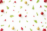 Christmas and New Year's composition. Top view of spruce branches, pine cones, red berries and bell on white background.