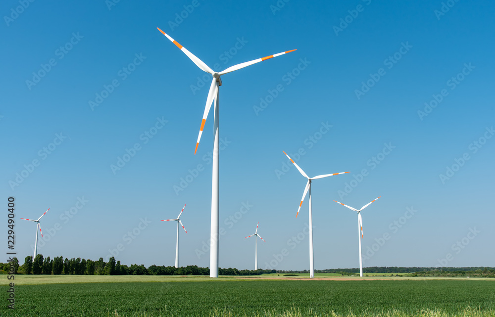 Wind power generators in front of a clear blue sky seen in Germany Wind power generators in front of a clear blue sky seen in Germany