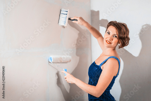 Sexy girl who is builder, painter, worker being in a renovated room