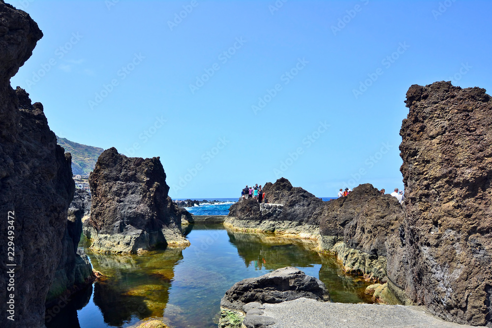 Rocky shore and natural lava-rock  pool, Porto Moniz, Madeira island, Portugal