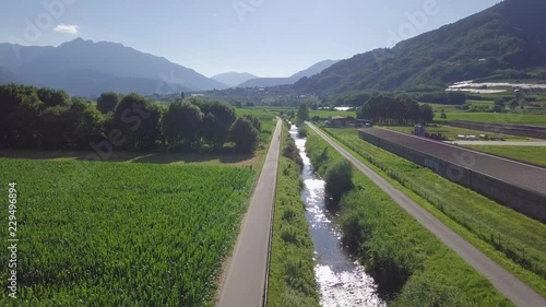 Aerial panoramic view of a biker with views of Sugana Valley, Italy. Drone flying forward photo