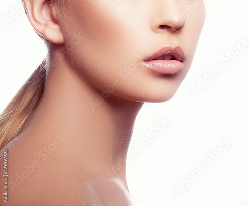 Beauty girl model part of face with perfect skin  natural lips  neck. Skincare health beauty treatment concept. White background