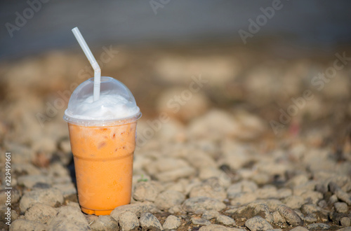 A glass of water is placed on the ground. photo