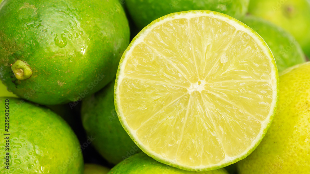 Close up of a half of green lime in a basket. Close up of a half of green lime in a basket.