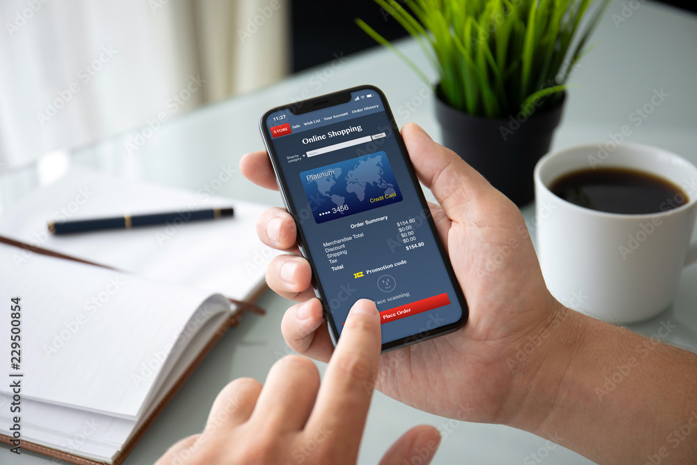 man hands holding phone with app online shopping on screen man hands holding phone with app online shopping on screen