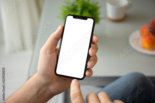 man hand holding phone with isolated screen in room house