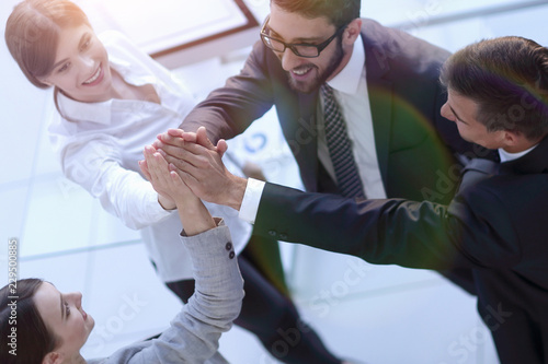 successful business team giving each other a high-five  standing in the office