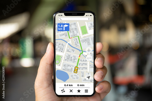 man hand holding phone with app navigation map on screen