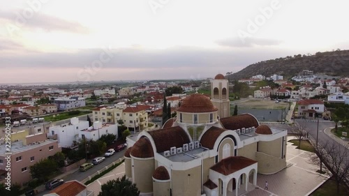 Aerial view flying over the rooftop of a monastery overlooking the port town of Oroklini, Cyprus photo