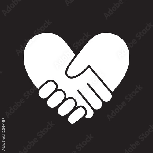 Handshake in form of heart on black background