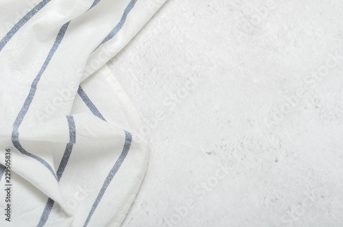 White clean towel on a light gray stone background. Minimalist kitchen