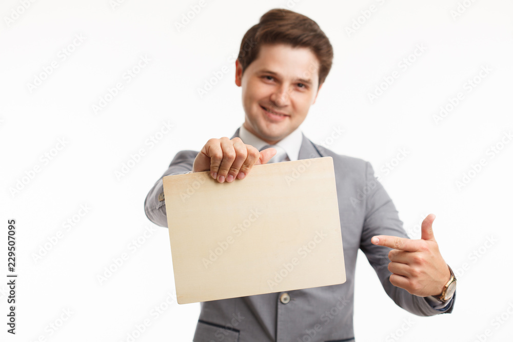 Businessman showing signboard. In studio on a white background Businessman showing signboard. In studio on a white background