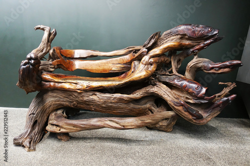 Abstract wooden bench made from tree trunk, isolated art object 