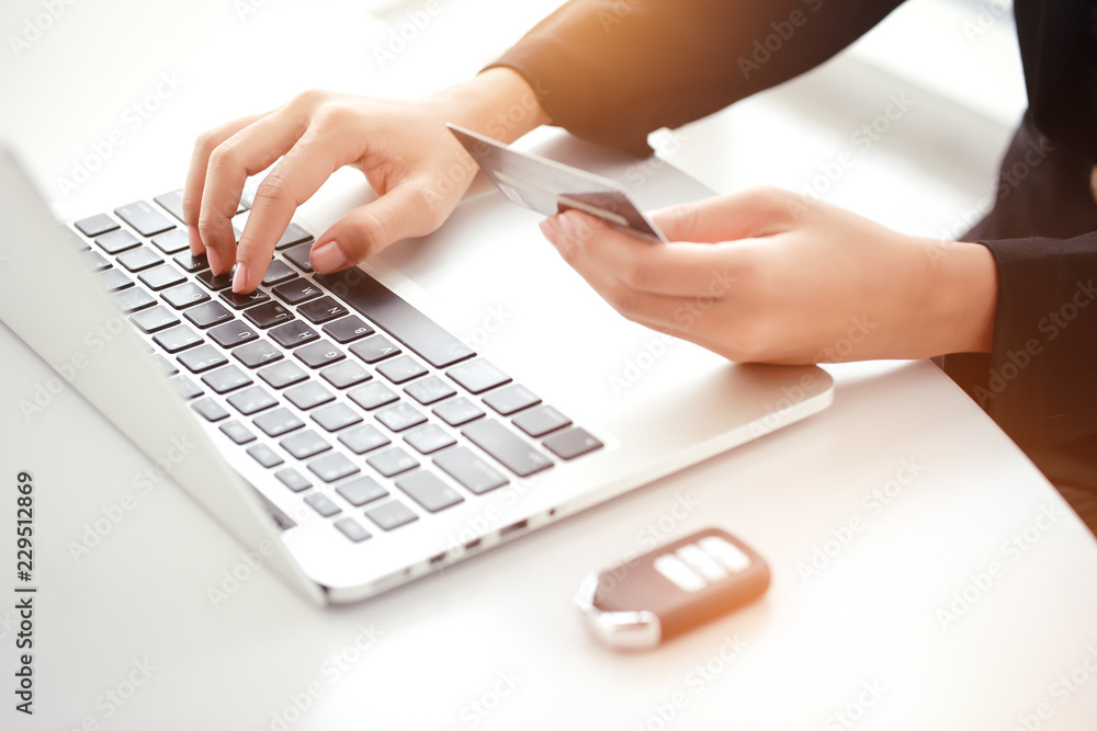woman hands use laptop computer, credit card and car key for monthly payment woman hands use laptop computer, credit card and car key for monthly payment