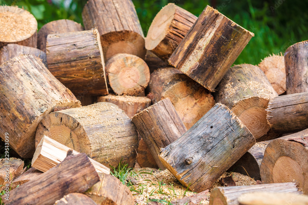 Firewood for heating in winter. Pile of cutting pine wood outdoors Firewood for heating in winter. Pile of cutting pine wood outdoors