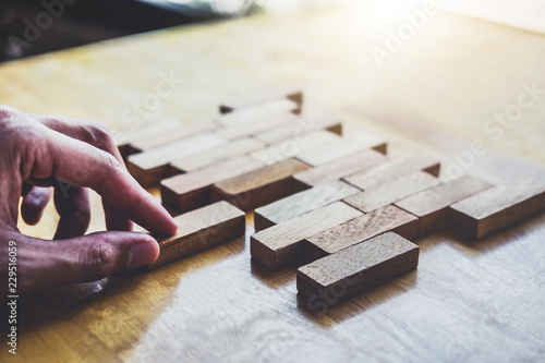Business concept for growth success process, Images of hand of businesspeople placing and pulling wood block to complete in game and success in strategy