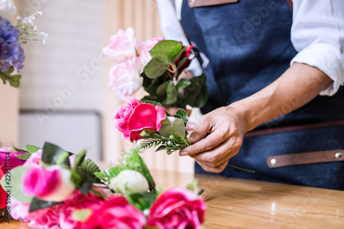 Arranging artificial flowers vest decoration at home, Young woman florist work making organizing diy artificial flower, craft and hand made concept