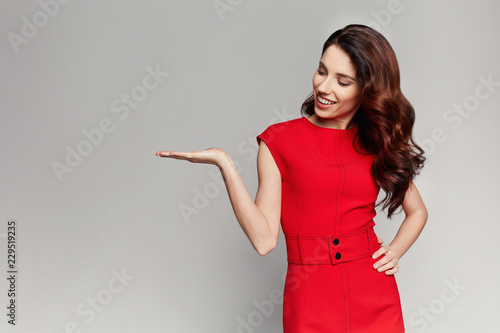 Beautiful woman in a red dress. Fashionable business woman.