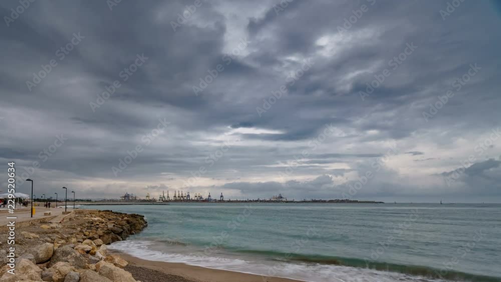 Cranes, port and passers-by near beach timelapse Cranes, port and passers-by near beach timelapse