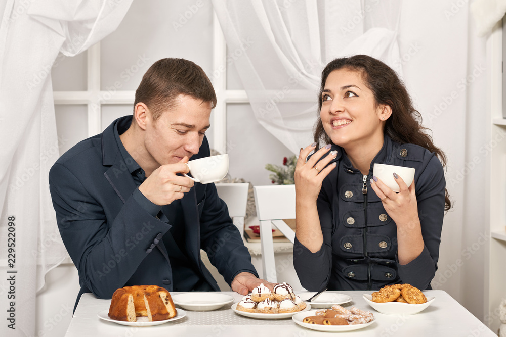 romantic couple drinking tea with cookies and talking romantic couple drinking tea with cookies and talking