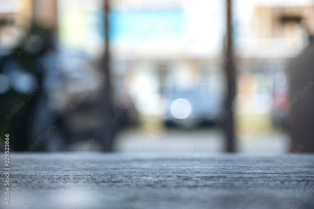 Fototapeta premium Wooden table in cafe with blur bokeh abstract vintage background