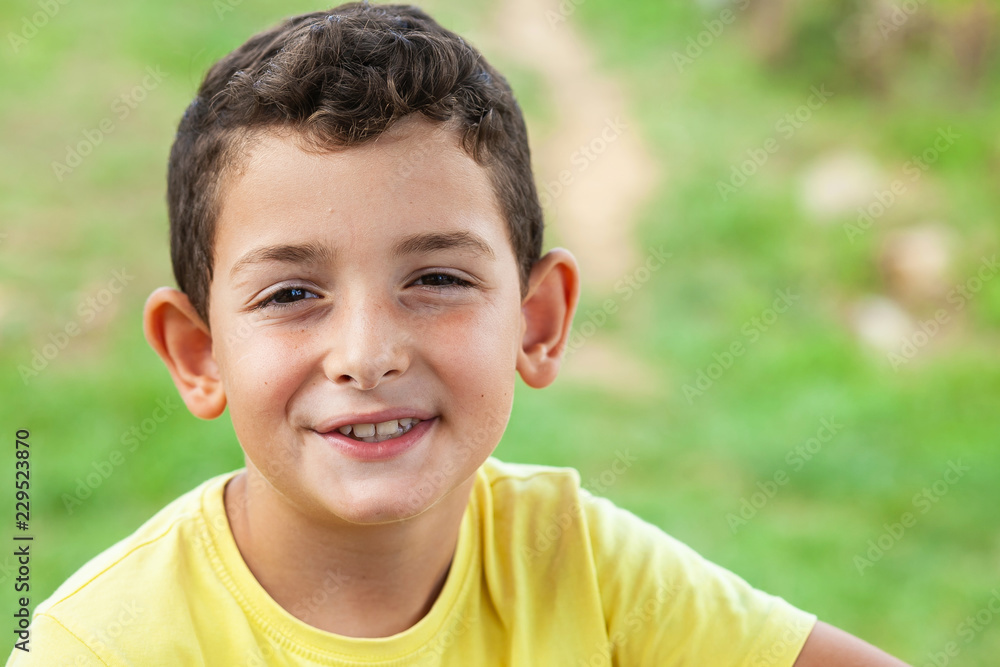 Portrait of happy smiling child boy outdoors. Concept of happy family or successful adoption or parenting. Portrait of happy smiling child boy outdoors. Concept of happy family or successful adoption or parenting.