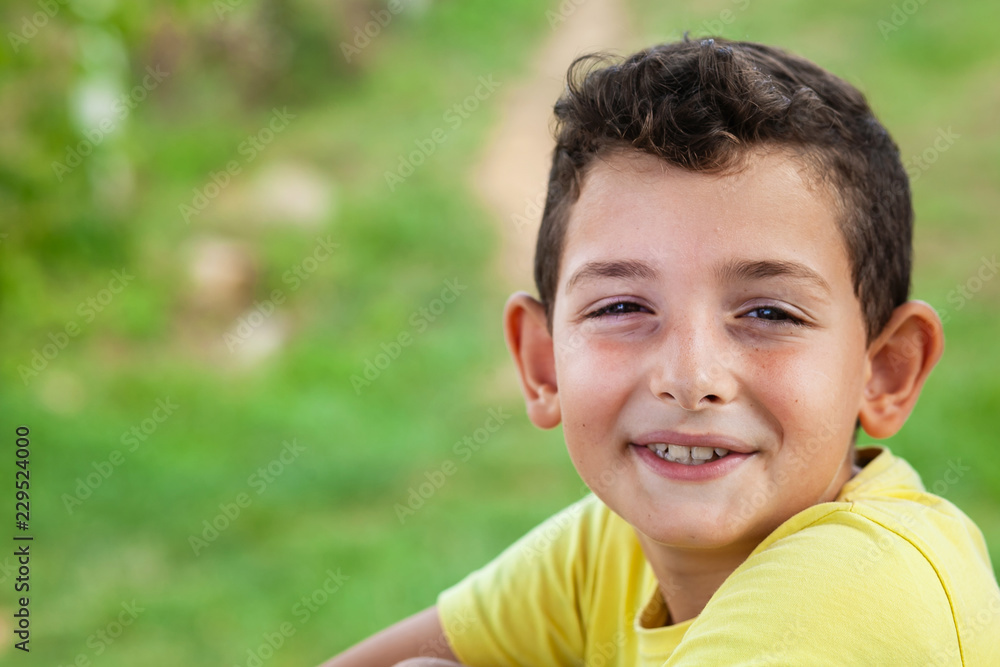 Portrait of happy smiling child boy outdoors. Concept of happy family or successful adoption or parenting. Portrait of happy smiling child boy outdoors. Concept of happy family or successful adoption or parenting.