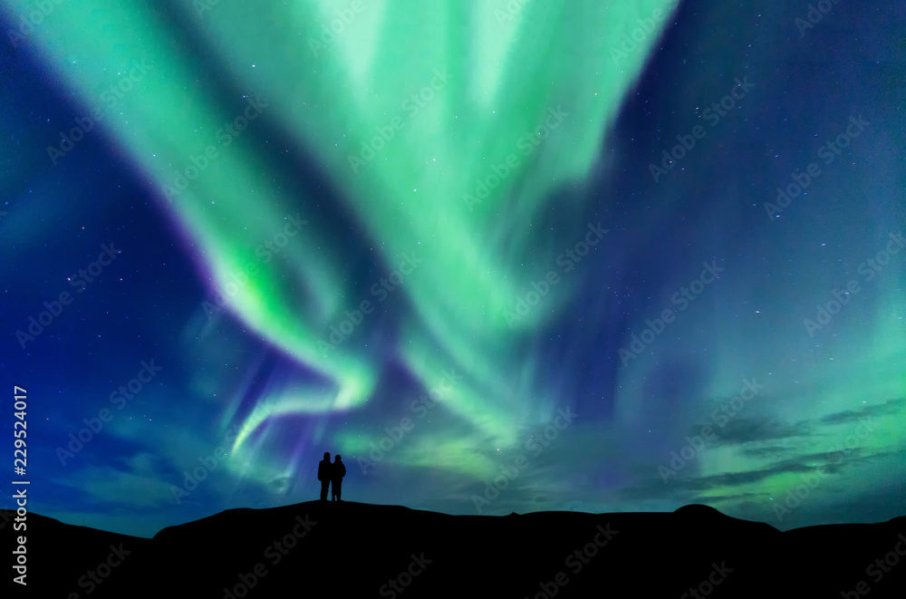 Aurora borealis with silhouette love romantic couple on the mountain ...