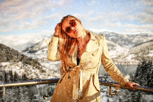Slim young blond woman and winter time in Alps. 