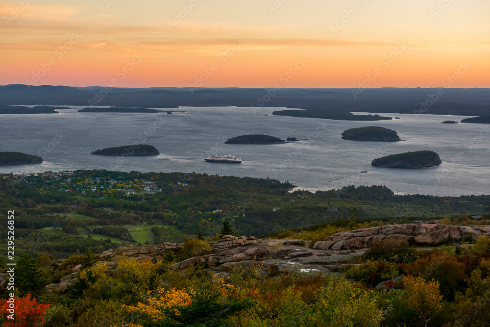 Dawn from a mountain overlooking the bay of the Atlantic Ocean with islands and the town. USA. Park Acadia. Mount Cadilac.
