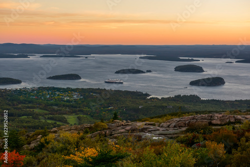 Dawn from a mountain overlooking the bay of the Atlantic Ocean with islands and the town. USA. Park Acadia. Mount Cadilac. 
