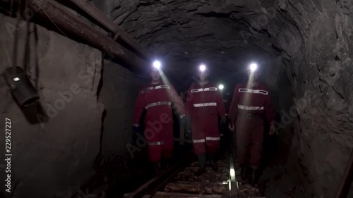 Workers in mine perforating the rock using a pneumatic drill