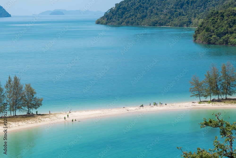 White sand beach and Long-tail boat at Kham-Tok Island (koh-kam-tok), The beautiful sea Ranong Province, Thailand.