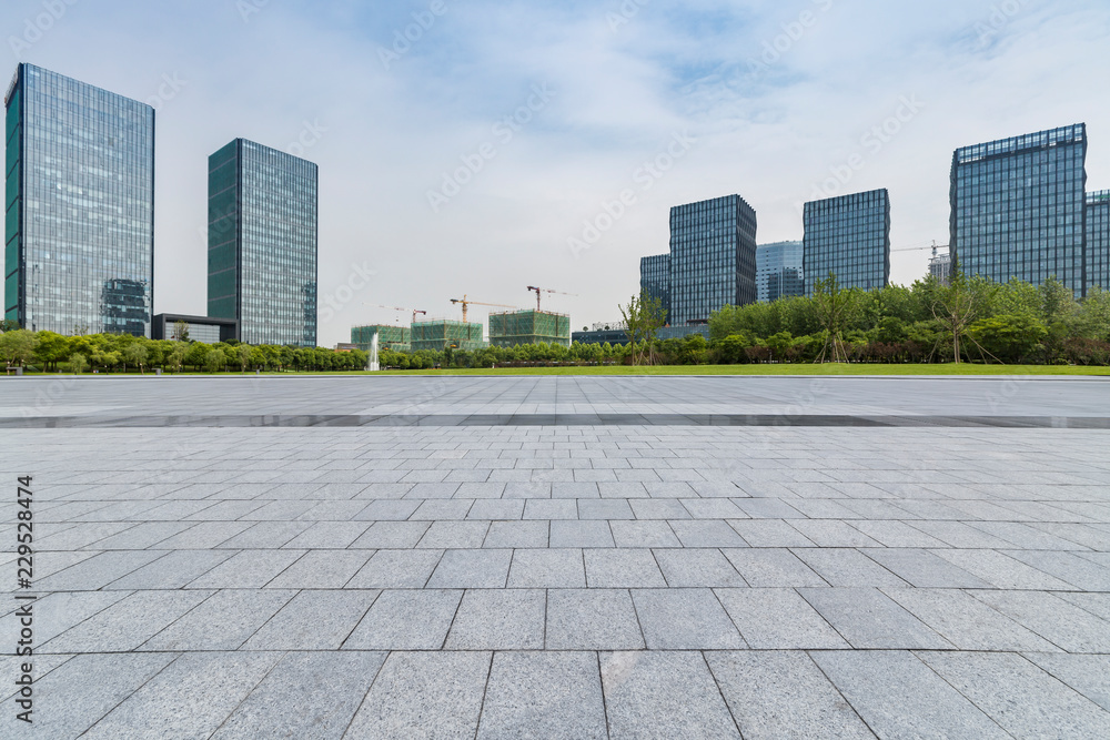 Panoramic skyline and modern business office buildings with empty road,empty concrete square floor Panoramic skyline and modern business office buildings with empty road,empty concrete square floor