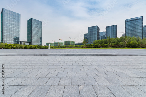 Panoramic skyline and modern business office buildings with empty road,empty concrete square floor © MyCreative
