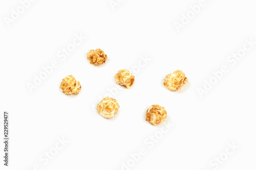 A few pieces caramel popcorn on white background.